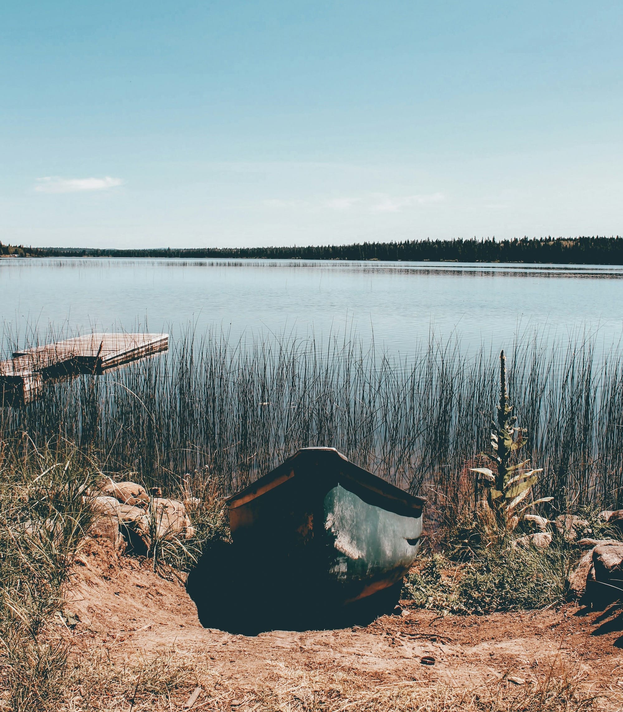 brown wooden boat on lake during daytime