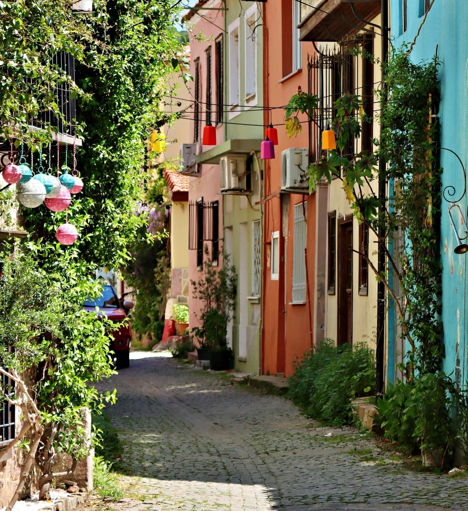 a cobblestone street lined with colorful buildings